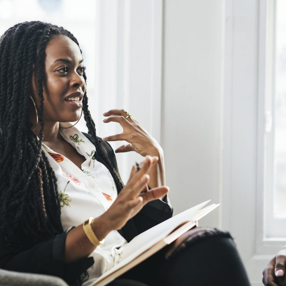 Professional businesswomen talking Black female boss talking at a meeting